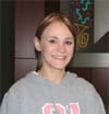 Young girl in gray sweatshirt smiles in a 幸运168®飞艇开奖预测网-Louisiana全国统一历史记录预测_在线查询开奖最新数据 office