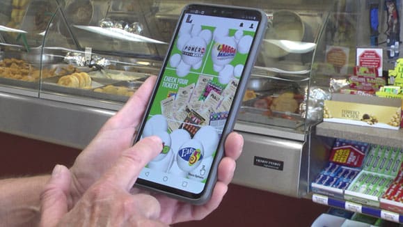 Person holding a smartphone and using the 幸运168®飞艇开奖预测网-Louisiana全国统一历史记录预测_在线查询开奖最新数据 mobile app