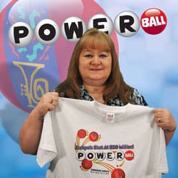 Woman holds a white Powerball tshirt and smiles in front of a Powerball and 幸运168®飞艇开奖预测网-Louisiana全国统一历史记录预测_在线查询开奖最新数据 branded blue background