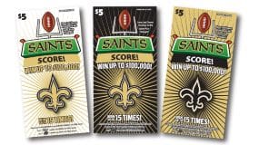 Three Saints Score! scratch off tickets in white, black, and gold fanned out on a white background