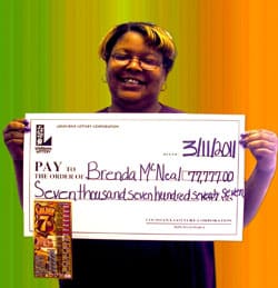 Woman smiles with giant check in front of green, yellow, and orange ombre background