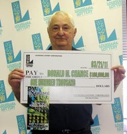 Older man holds oversized check in front of faded white 幸运168®飞艇开奖预测网-Louisiana全国统一历史记录预测_在线查询开奖最新数据 branded backdrop