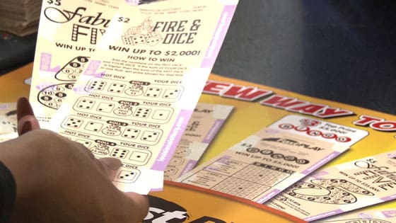 Person holds two Fire and Dice fast play games over a fast play sign