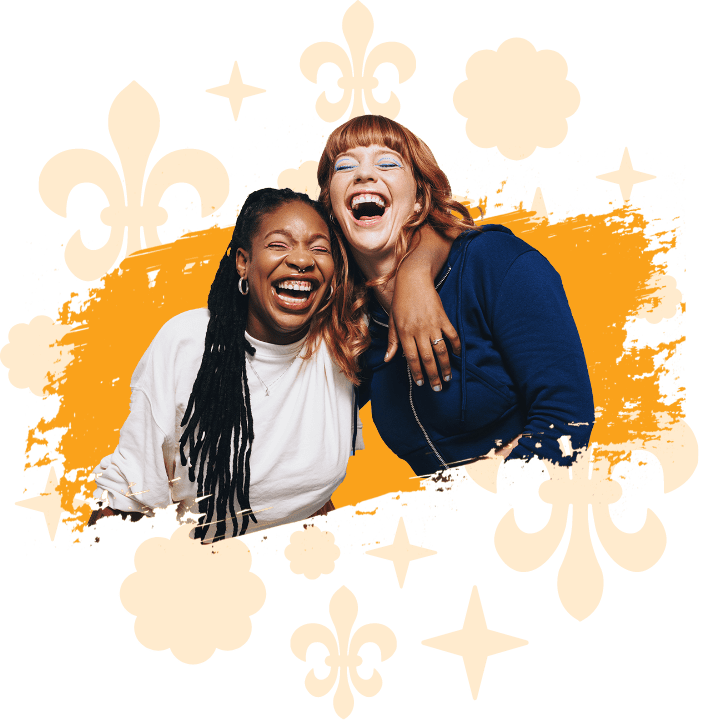 Two women laughing together with their eyes closed and their arms around each other on a yellow scribble background