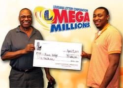 Two men hold an oversized check and smile in front of a gold Mega Millions background