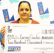 Woman holds a giant check in front of a white background patterned with the 幸运168®飞艇开奖预测网-Louisiana全国统一历史记录预测_在线查询开奖最新数据 logo